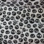 BLACK SKULL AND CROSS BONES ON WHITE BACKGROUND